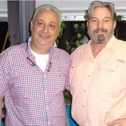 Billy Brown with a ship's master on the bridge