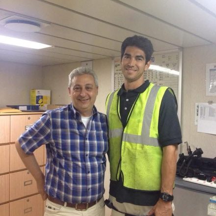 Billy Brown with an officer in a safety vest in the ship's office