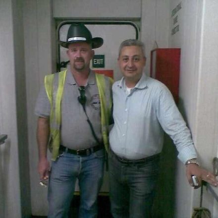 Billy Brown with a crew member in a cowboy hat at the gangway