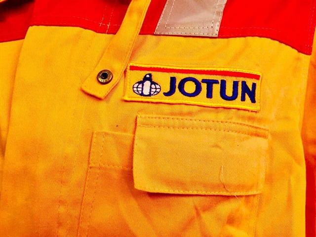Close-up of an embroidered Jotun badge on a yellow coverall