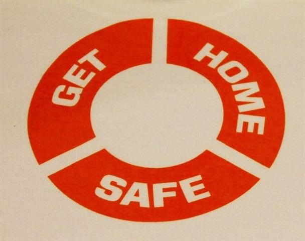 Close-up of the orange Get Home Safe print on a T-shirt